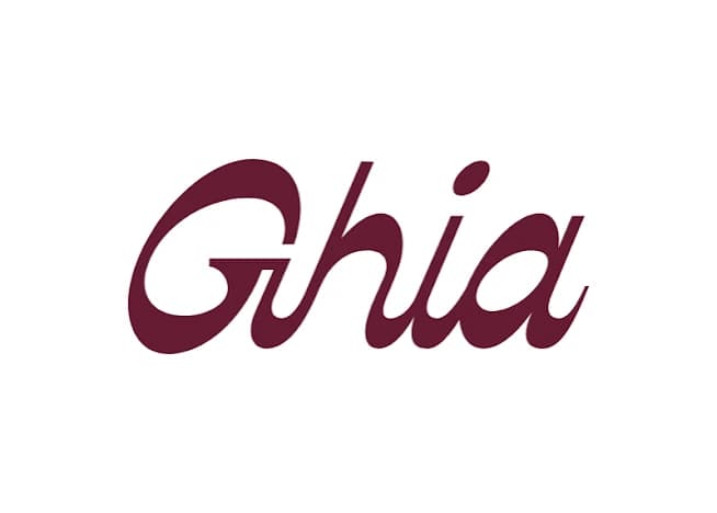 Ghia homepage with ribbed glass apéritif bottles beside stacked Le Spritz cans on a cream and burgundy layout